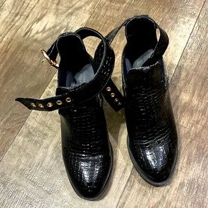 Topshop heeled boots with straps. They are black and in good condition